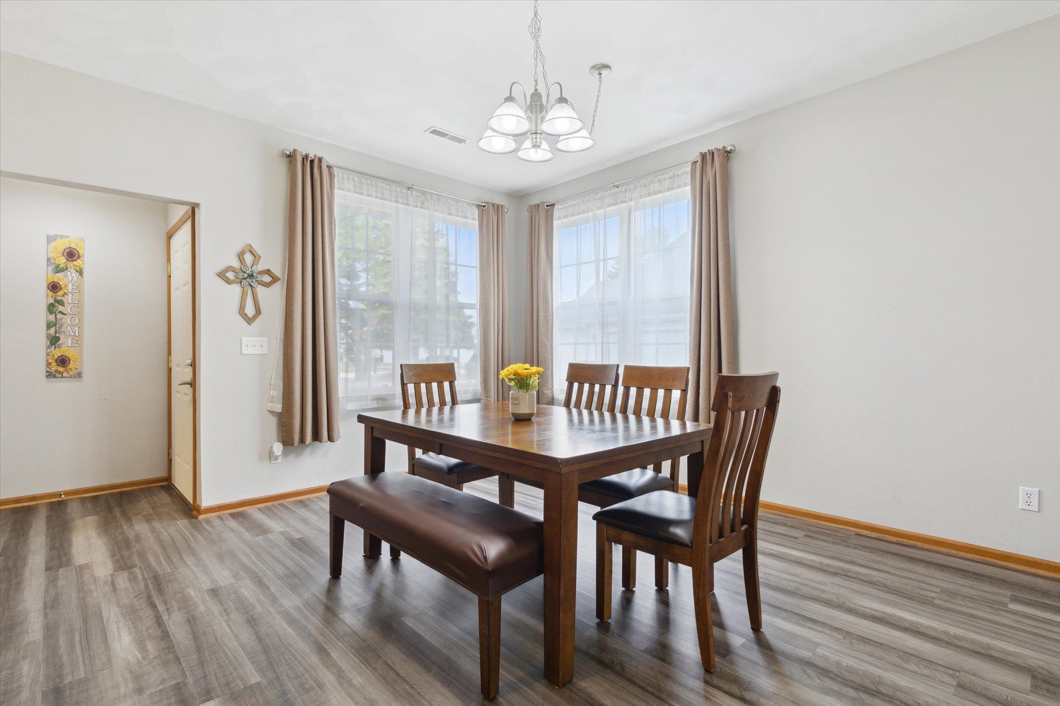 10156 Metalmark Lane, Unit 2 Roscoe, IL 61073 - Photo 7 of 38 a view of a dining room with furniture window and wooden floor