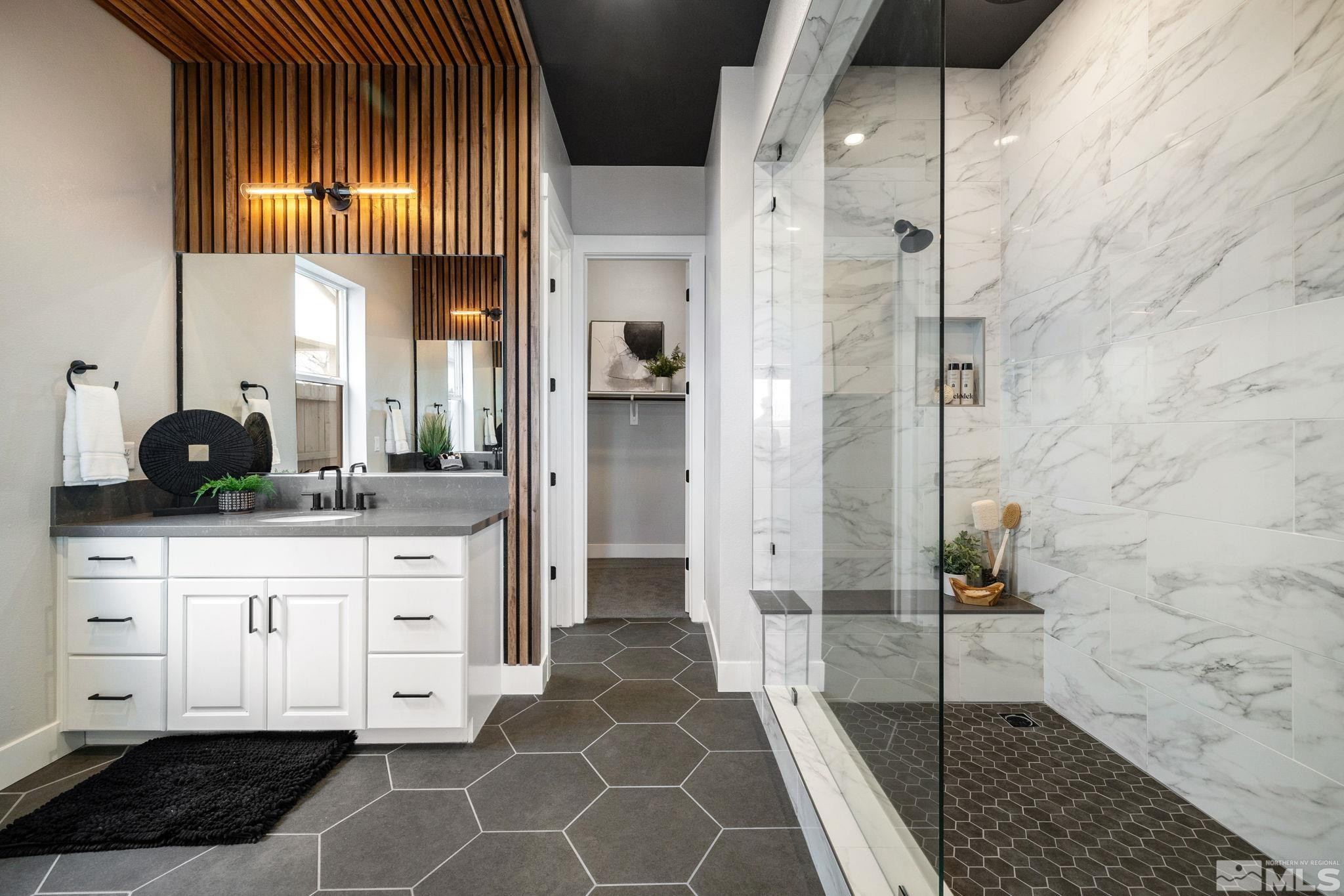 2913 Ruby Desert Drive Reno, NV 89521 - Photo 22 of 39 a bathroom with a double vanity sink a toilet a mirror and shower