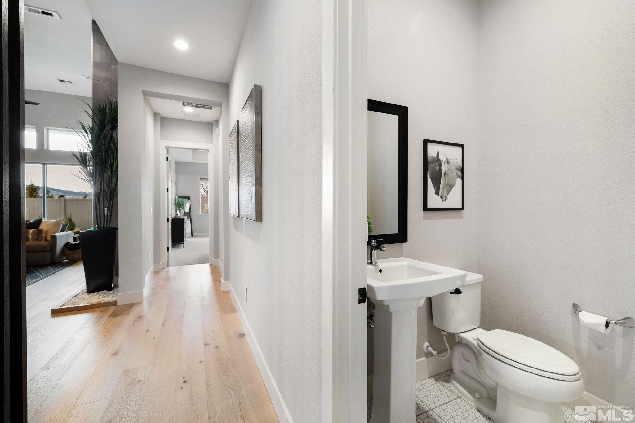 2913 Ruby Desert Drive Reno, NV 89521 - Photo 27 of 39 a bathroom with a toilet sink and mirror