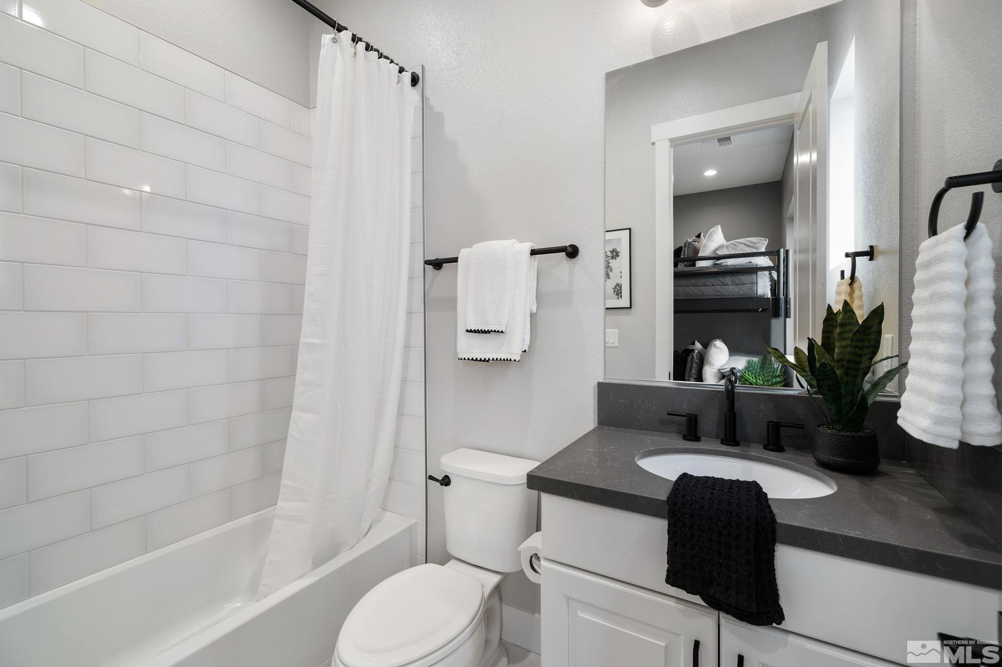 2913 Ruby Desert Drive Reno, NV 89521 - Photo 29 of 39 a bathroom with a granite countertop sink toilet and shower
