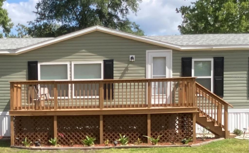 18137 Hollister Road Orlando, FL 32820 - Photo 20 of 27 a front view of a house with large windows and a fence