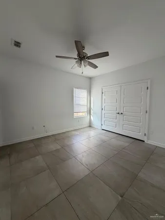 a view of a livingroom with a ceiling fan and window
