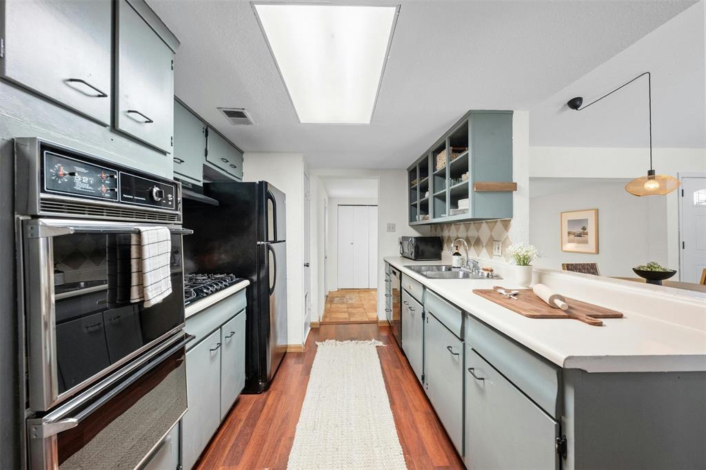 4610 South 1st Street Austin, TX 78745 - Photo 14 of 23 a kitchen with a sink stove and refrigerator