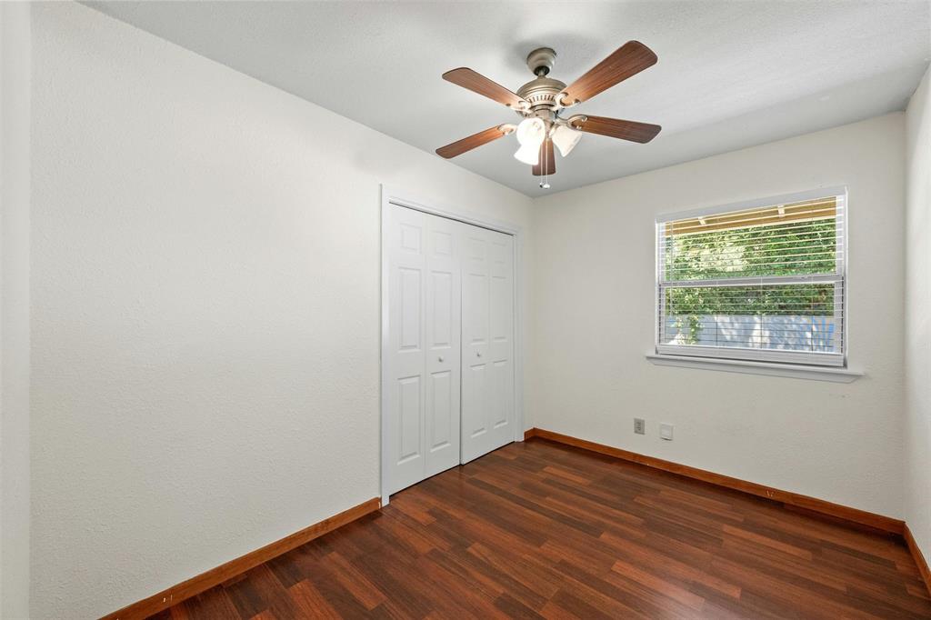 4610 South 1st Street Austin, TX 78745 - Photo 17 of 23 an empty room with wooden floor fan and windows
