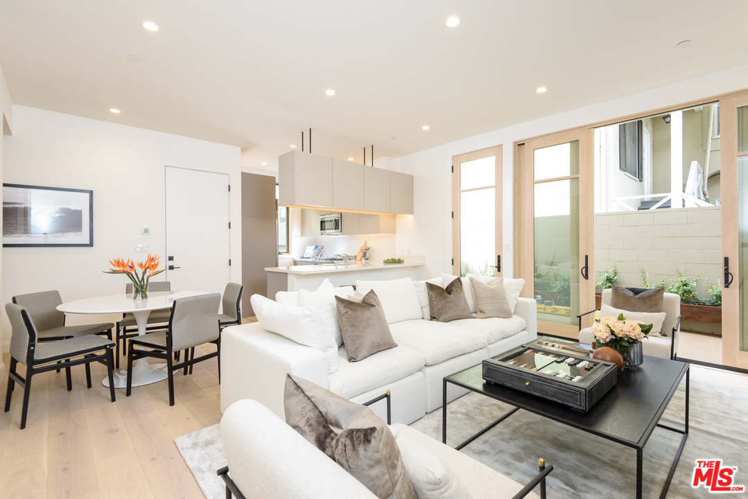 956 5th Street, Unit C Santa Monica, CA 90403 - Photo 3 of 13 a living room with furniture and a large window