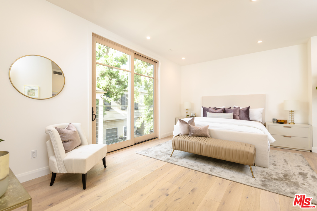 956 5th Street, Unit C Santa Monica, CA 90403 - Photo 7 of 13 a spacious bedroom with a bed a couch and a large window