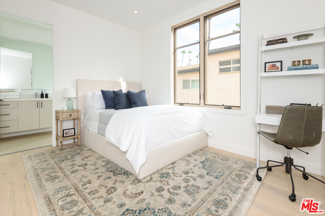 956 5th Street, Unit C Santa Monica, CA 90403 - Photo 10 of 13 a bedroom with a bed and large window