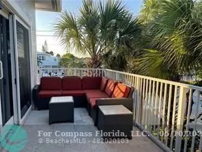 a balcony with furniture and a potted plant