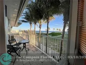 a view of a balcony with chairs and table