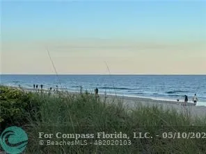 a view of a field of grass and trees