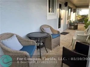 a view of a yard with plants and wooden fence