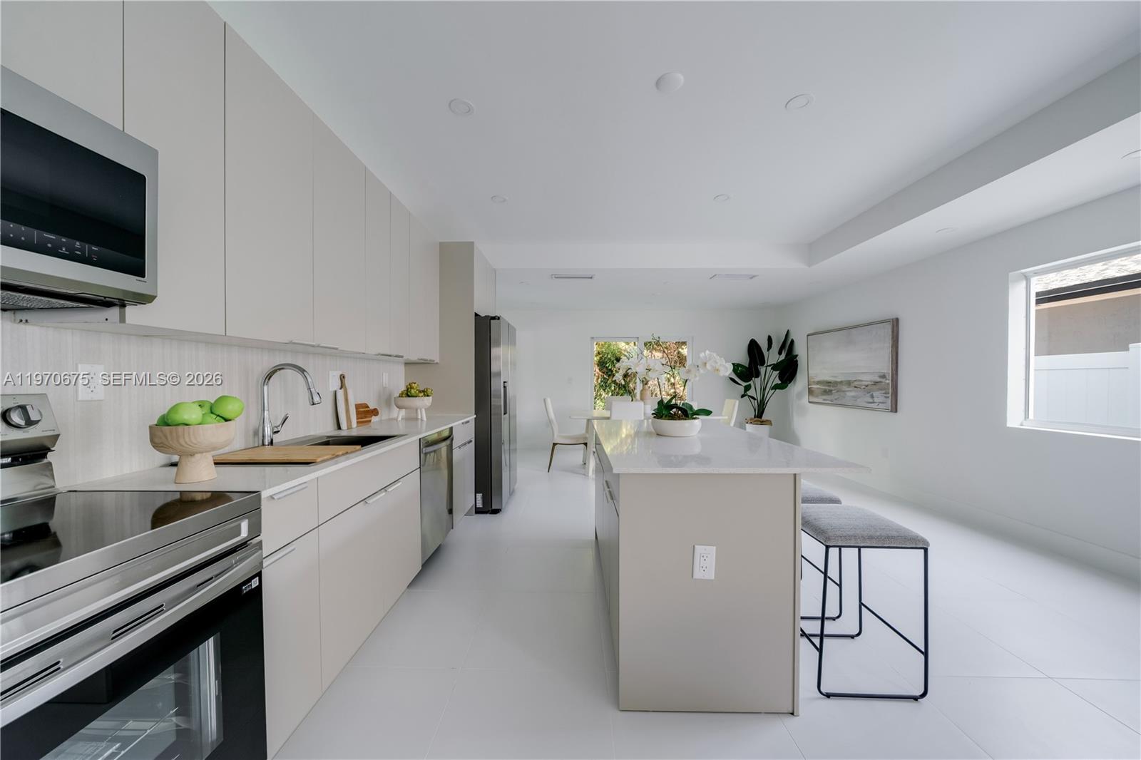 4789 Northwest 1st Street Miami, FL 33126 - Photo 13 of 28 a kitchen with a sink a stove and cabinets