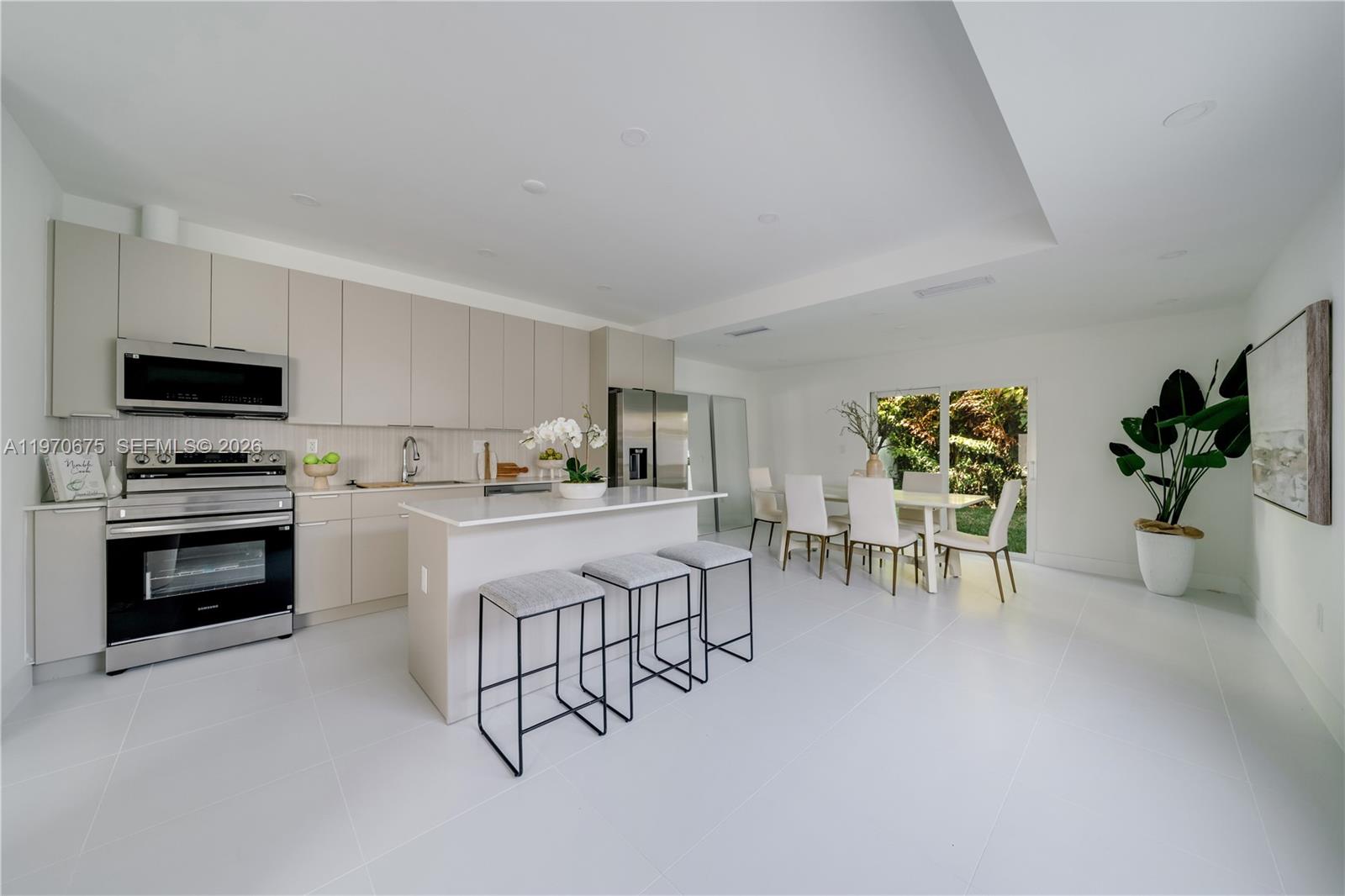 4789 Northwest 1st Street Miami, FL 33126 - Photo 14 of 28 a kitchen with white cabinets and stainless steel appliances