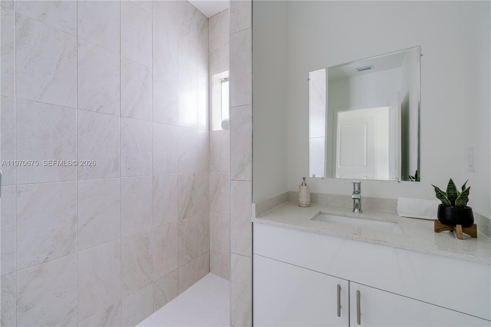 4789 Northwest 1st Street Miami, FL 33126 - Photo 25 of 28 a bathroom with a sink and a mirror