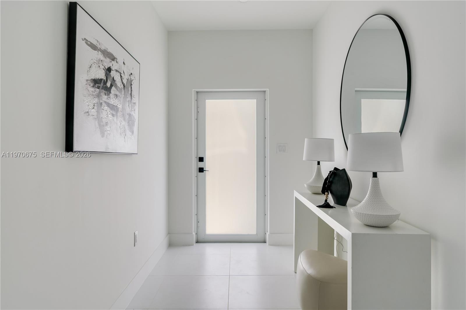 4789 Northwest 1st Street Miami, FL 33126 - Photo 3 of 28 a view of a hallway to rooms and a mirror