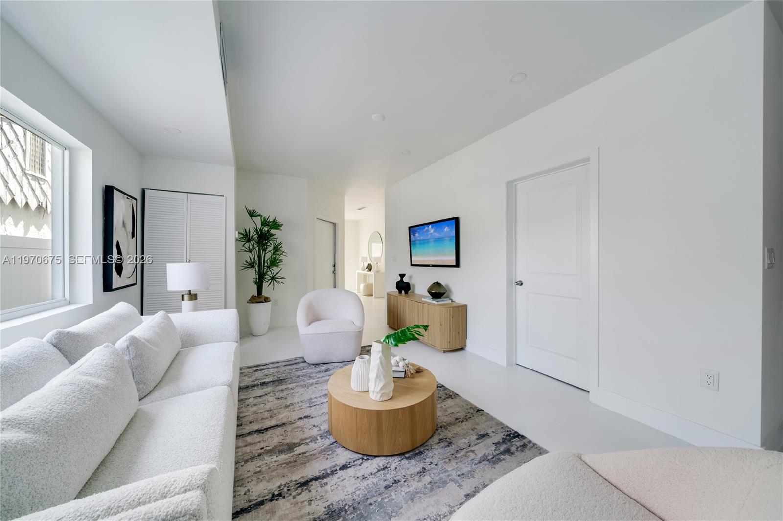 4789 Northwest 1st Street Miami, FL 33126 - Photo 7 of 28 a living room with furniture and a potted plant