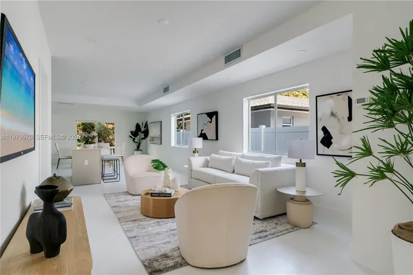 a living room with furniture and a mirror