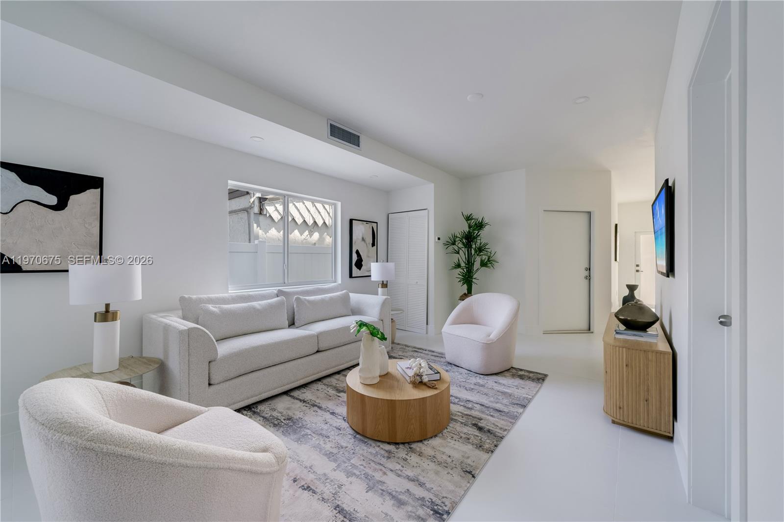 4789 Northwest 1st Street Miami, FL 33126 - Photo 9 of 28 a living room with furniture and a mirror