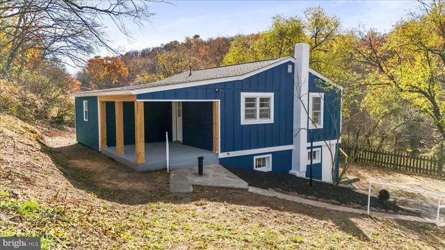 a view of a house with a yard covered in snow