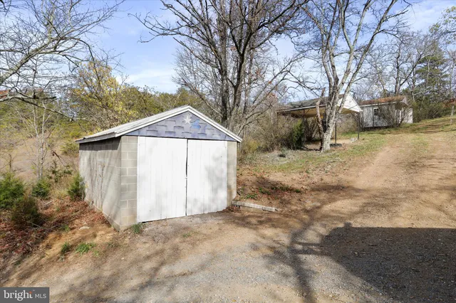 a view of a house with a yard covered in snow