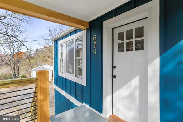 a view of a balcony with furniture and front door
