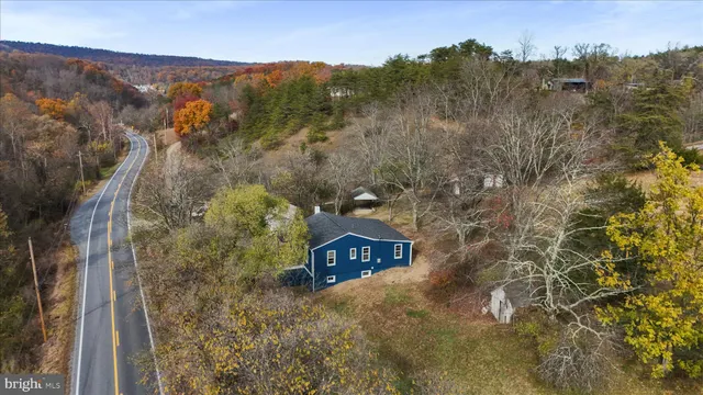 a view of a dry yard with mountains in the background