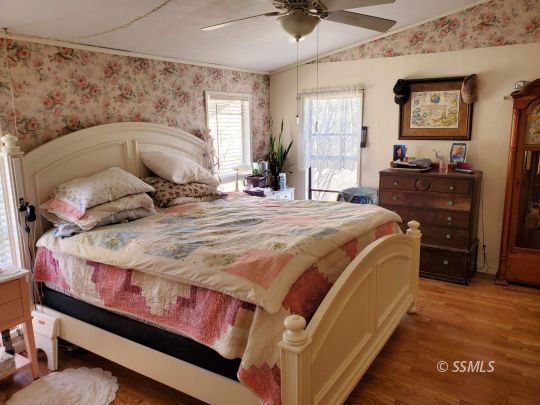 8926 Caliente Bodfish Road Caliente, CA 93518 - Photo 11 of 43 a bedroom with a bed and wooden floor