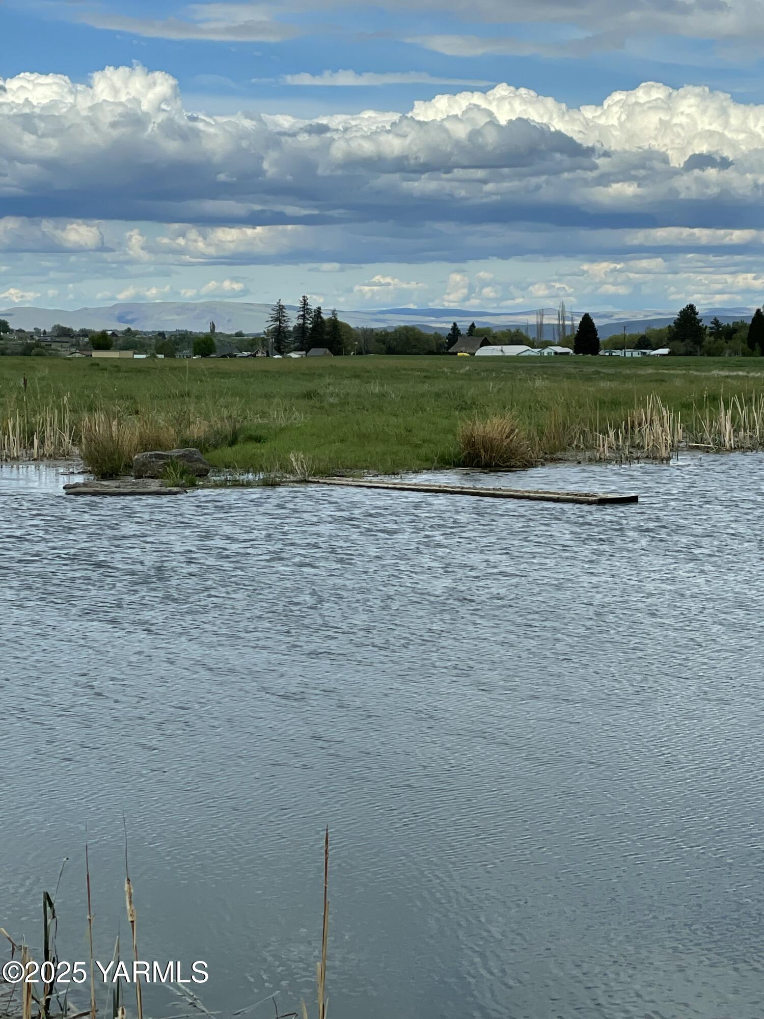 14530 Rutherford Road Yakima, WA 98903 - Photo 17 of 33 a view of a lake with a house in the background