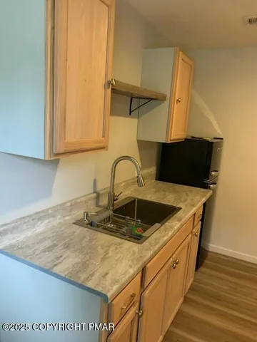 a kitchen with sink cabinets and microwave