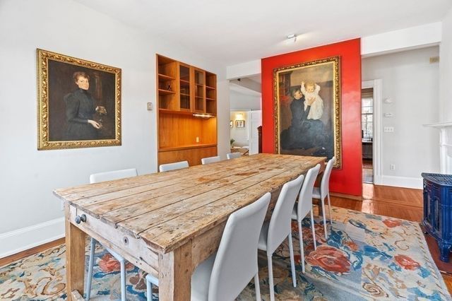 a dining room with furniture and wooden floor