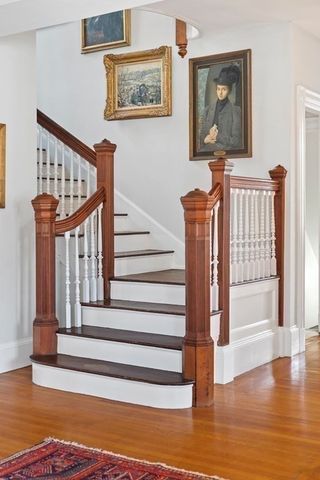 a view of entryway with wooden floor and front door