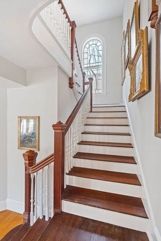 a view of entryway and hall with wooden floor
