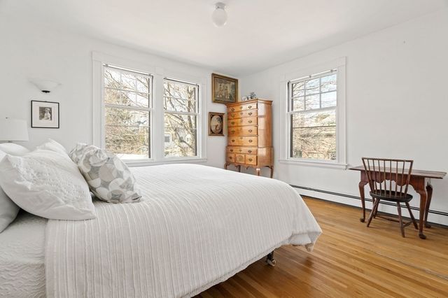 a bedroom with a bed chair and a window