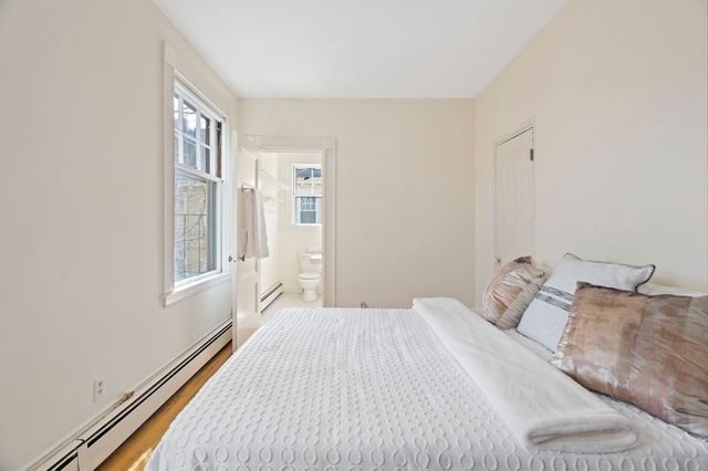 a bedroom with a bed and a window