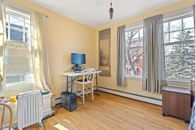 a workspace with furniture window and wooden floor