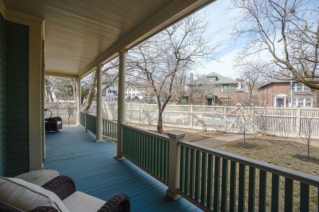 a view of a porch with furniture and wooden deck