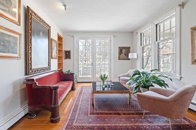 a living room with furniture potted plant and a window