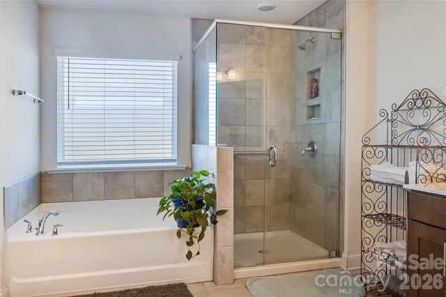 a bathroom with a granite countertop sink vanity and mirror