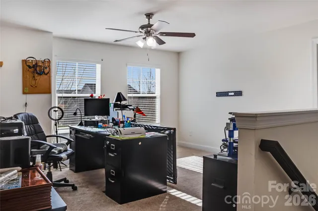 a living room with furniture a window and a lamp