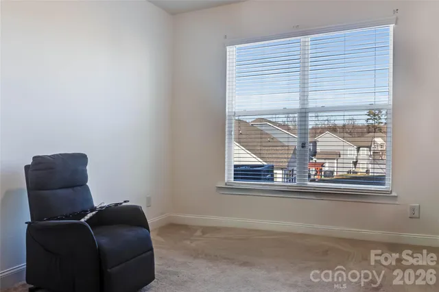 a view of a livingroom with furniture and staircase