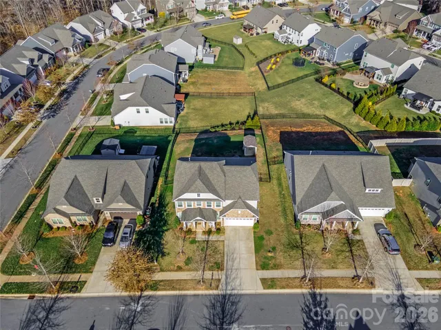 an aerial view of a house with swimming pool garden and mountain view