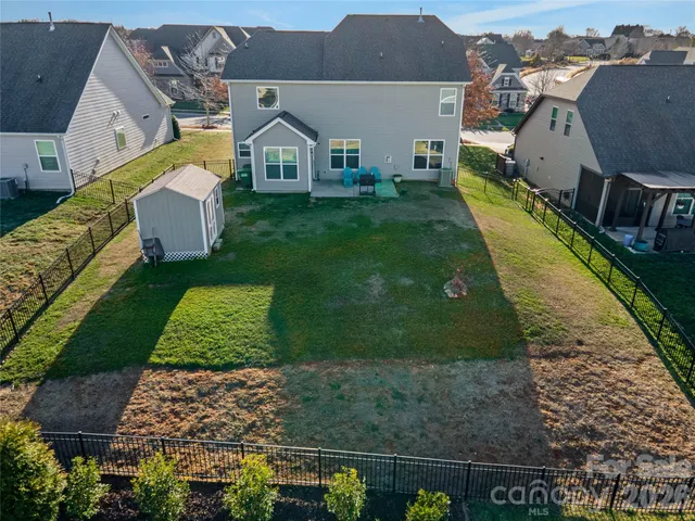 a front view of a house with a yard porch and wooden fence