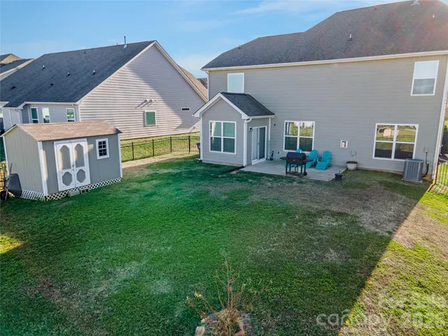 an aerial view of a house with a yard basket ball court and outdoor seating
