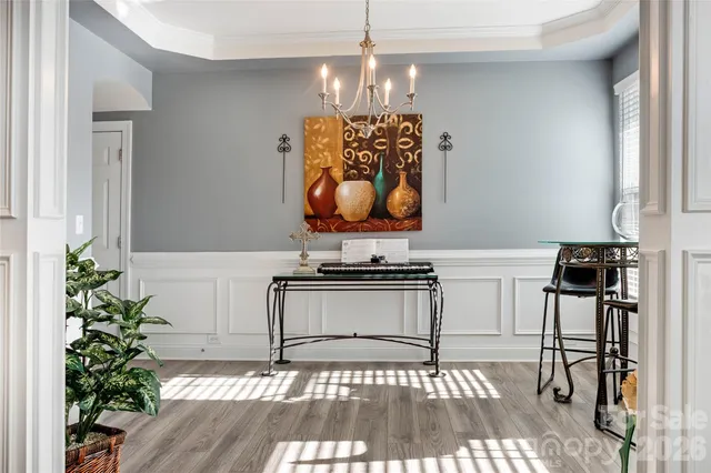 a dining room with furniture and wooden floor