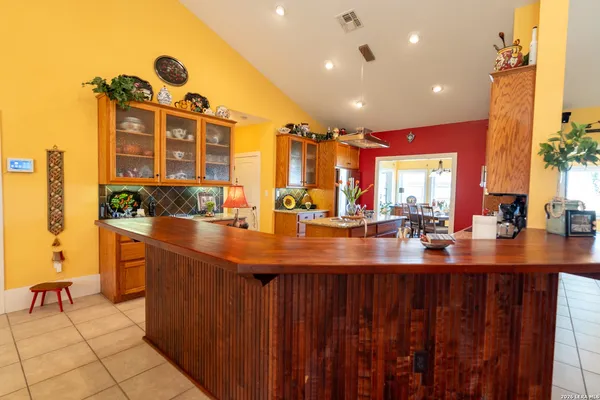 a kitchen with sink and view of living room