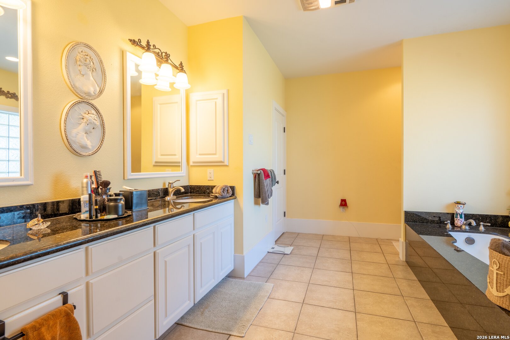 840 County Road 2250 Riviera, TX 78379 - Photo 35 of 45 a large bathroom with a double vanity sink and a mirror