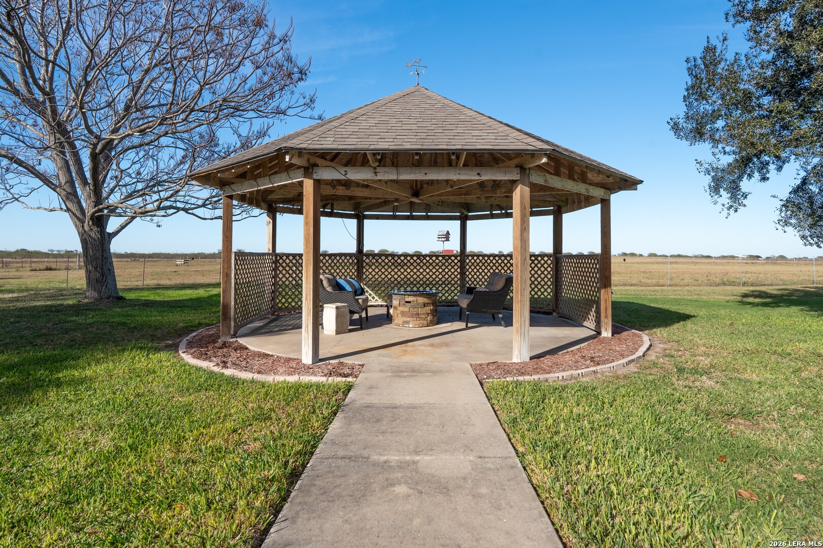 840 County Road 2250 Riviera, TX 78379 - Photo 6 of 45 a view of a backyard with table and chairs under an umbrella