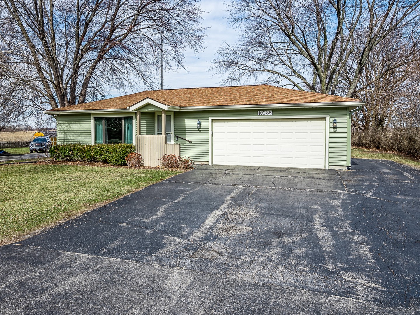 10235 Rich Road DeKalb, IL 60115 - Photo 1 of 21 a front view of house with yard and trees