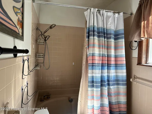 a bathroom with a shower toilet and sink