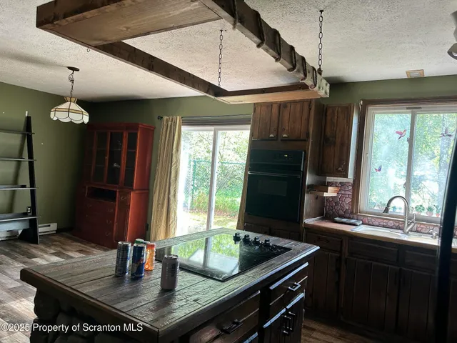 a kitchen with sink table and chairs